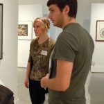 two people observing gallery exhibition