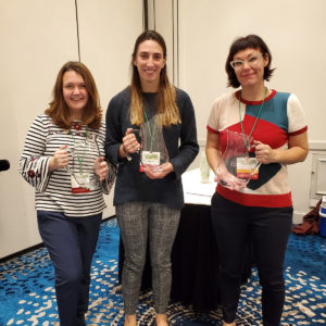 three people posing at conference