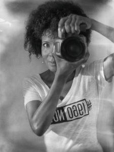 woman behind camera in black and white