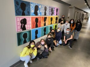 masked students in front of gallery wall